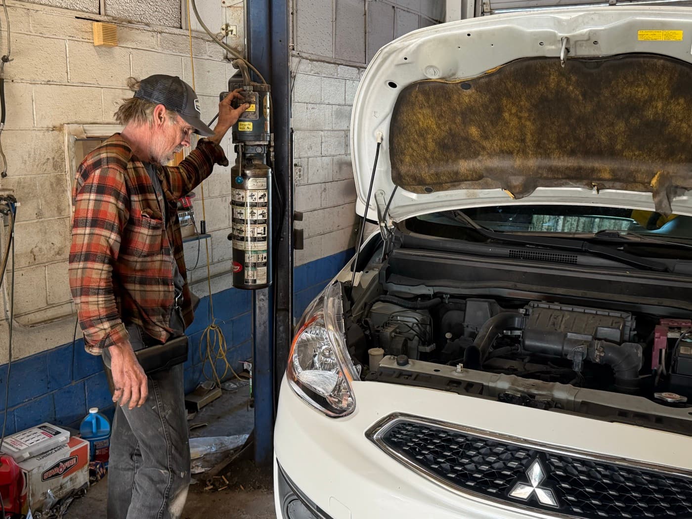 John Wanarski inspecting AC system with hood open