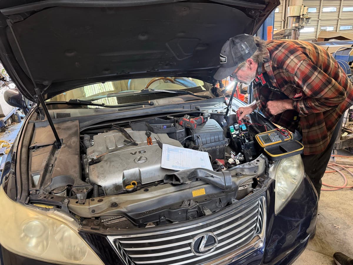 John Wanarski performing electrical diagnostics at JW Auto Service